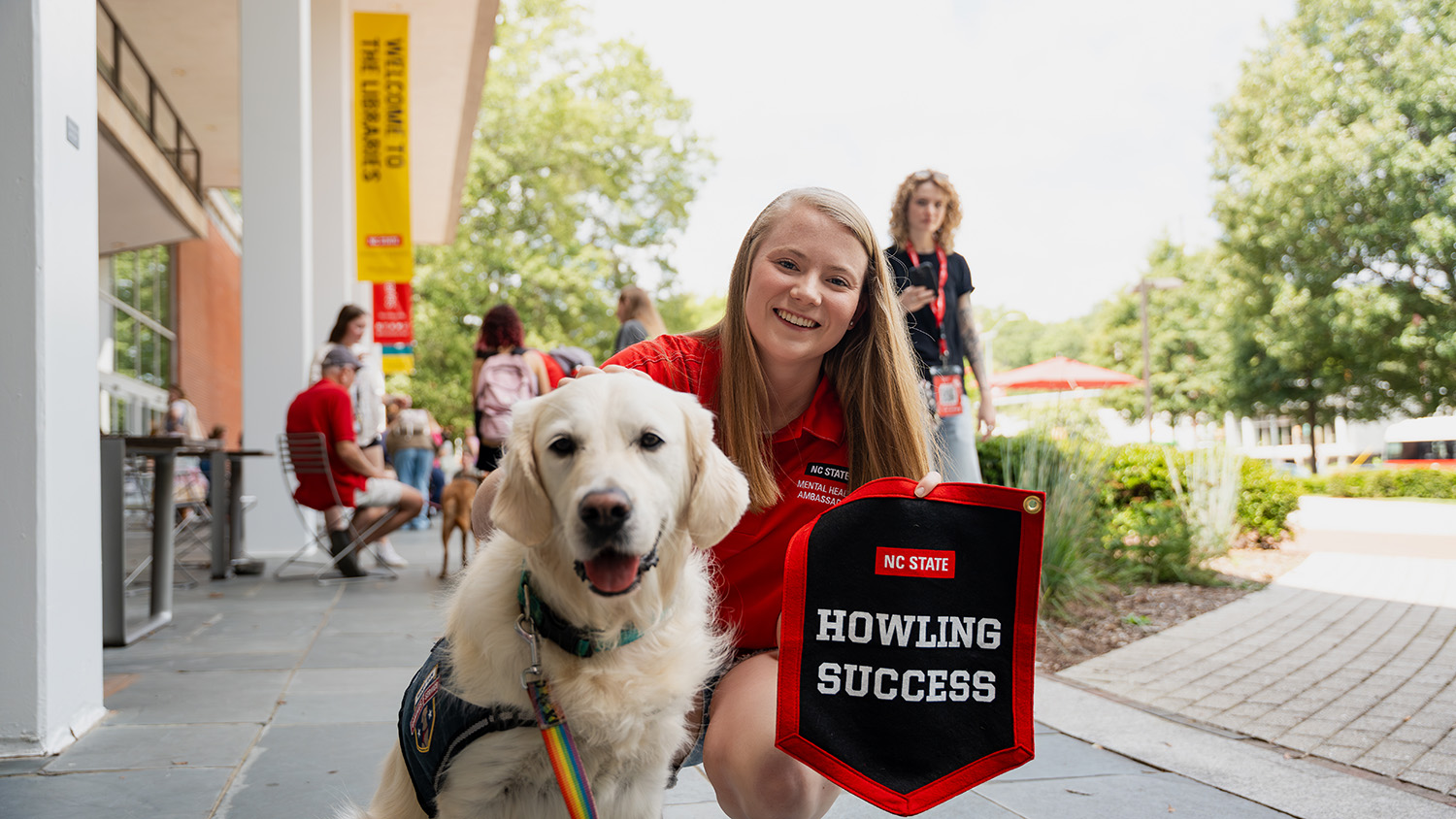 Kaylyn Poole takes a photo-op with a dog during a Pause for Paws event on campus.