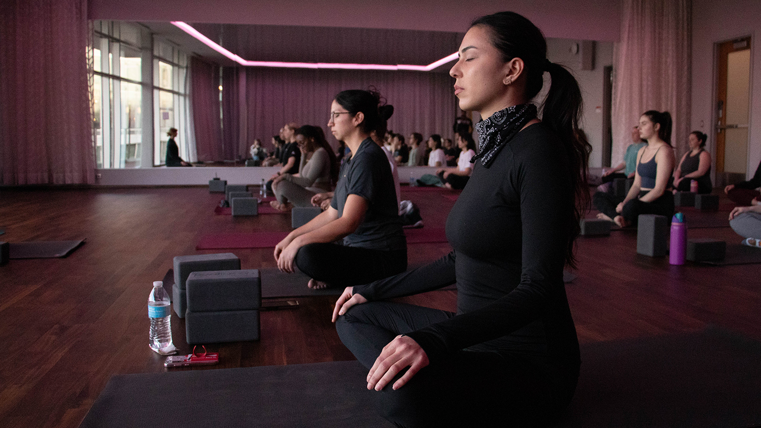 A group of students participates in a yoga exercise.