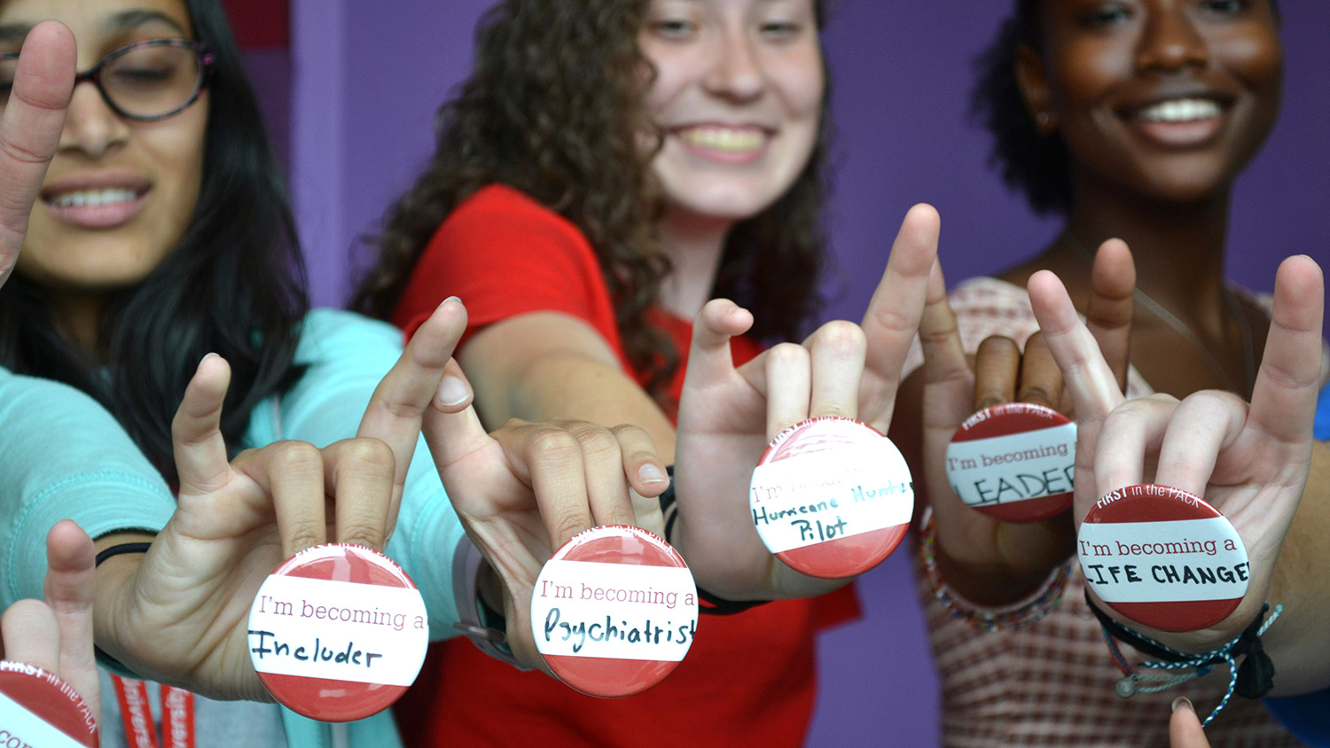 First in the Pack students proudly display their future career choices.