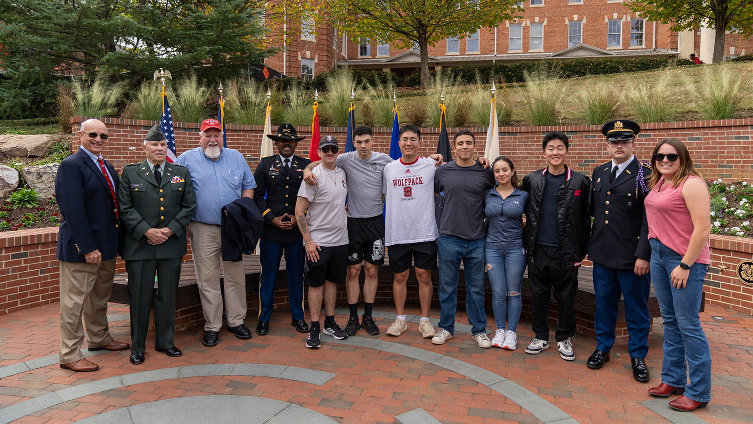 Veterans and their families gather for a photo at NC State's new Veterans Memorial Garden.