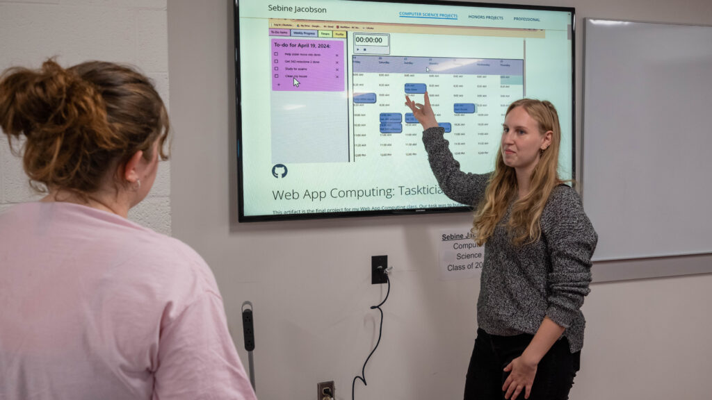 Sebine Jacobson, Class of 2024, presents an academic artifact she selected for her senior portfolio project for the UHP. 