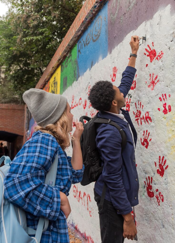 Students paint the free expression tunnel.