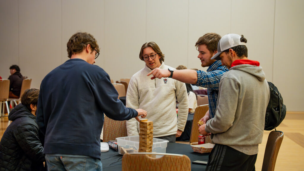 Incoming transfer students enjoy a game of Jenga. 