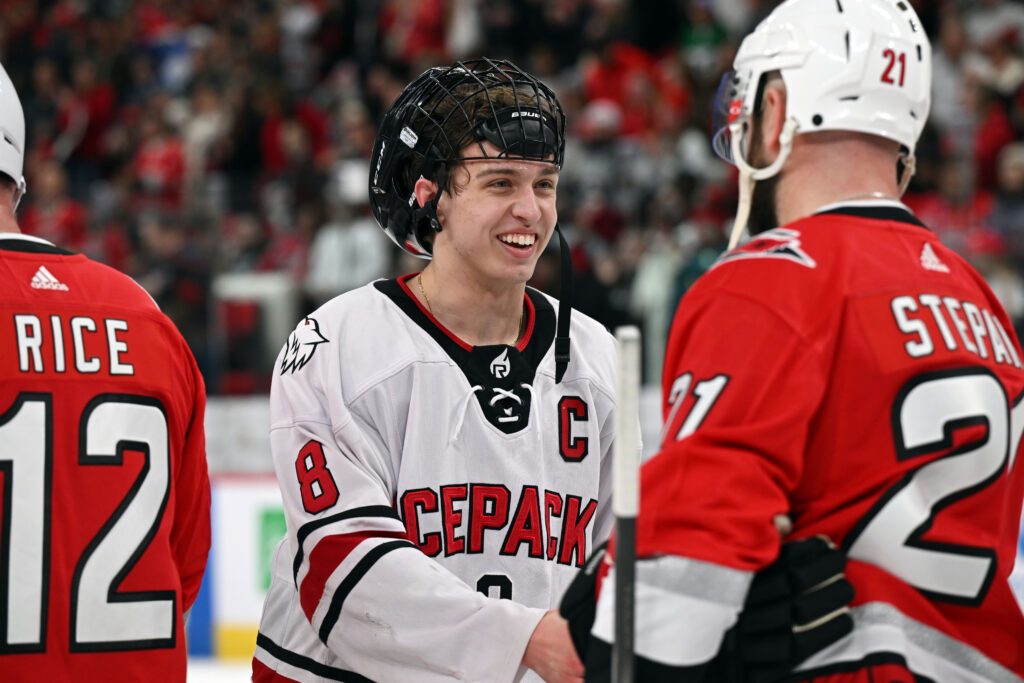 Icepack team captain Zach Herman shakes hands with Hurricanes alumnus Derek Stepan. Kaydee Gawlik | NC State Icepack