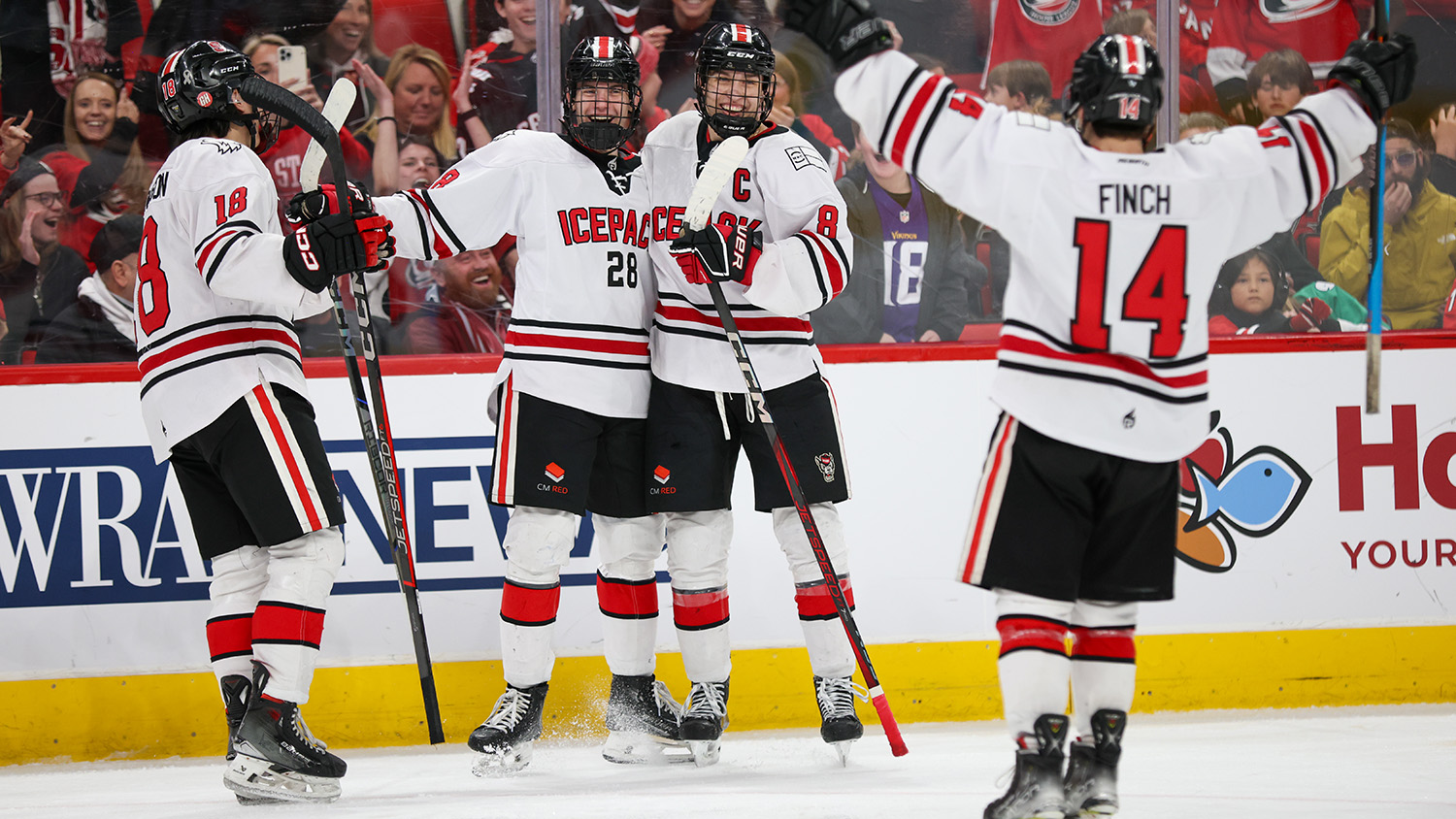 NC State Icepack players celebrate after scoring a goal at Lenovo Center.