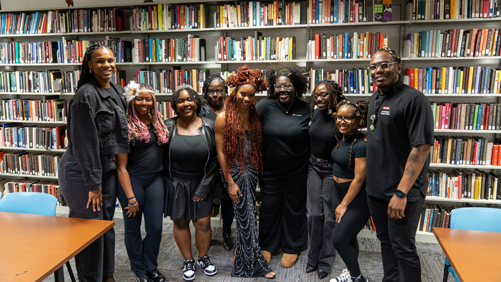 Danielle Moody gathers with African American Cultural Center staff during a gallery opening event.