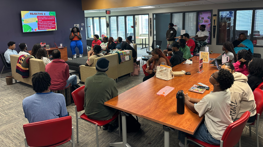 Danielle Moody addresses a group of students at an African American Cultural Center What's on the Table event.