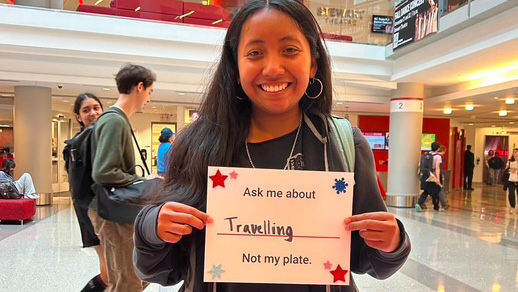 A student holds up a sign at a Campus Health event.