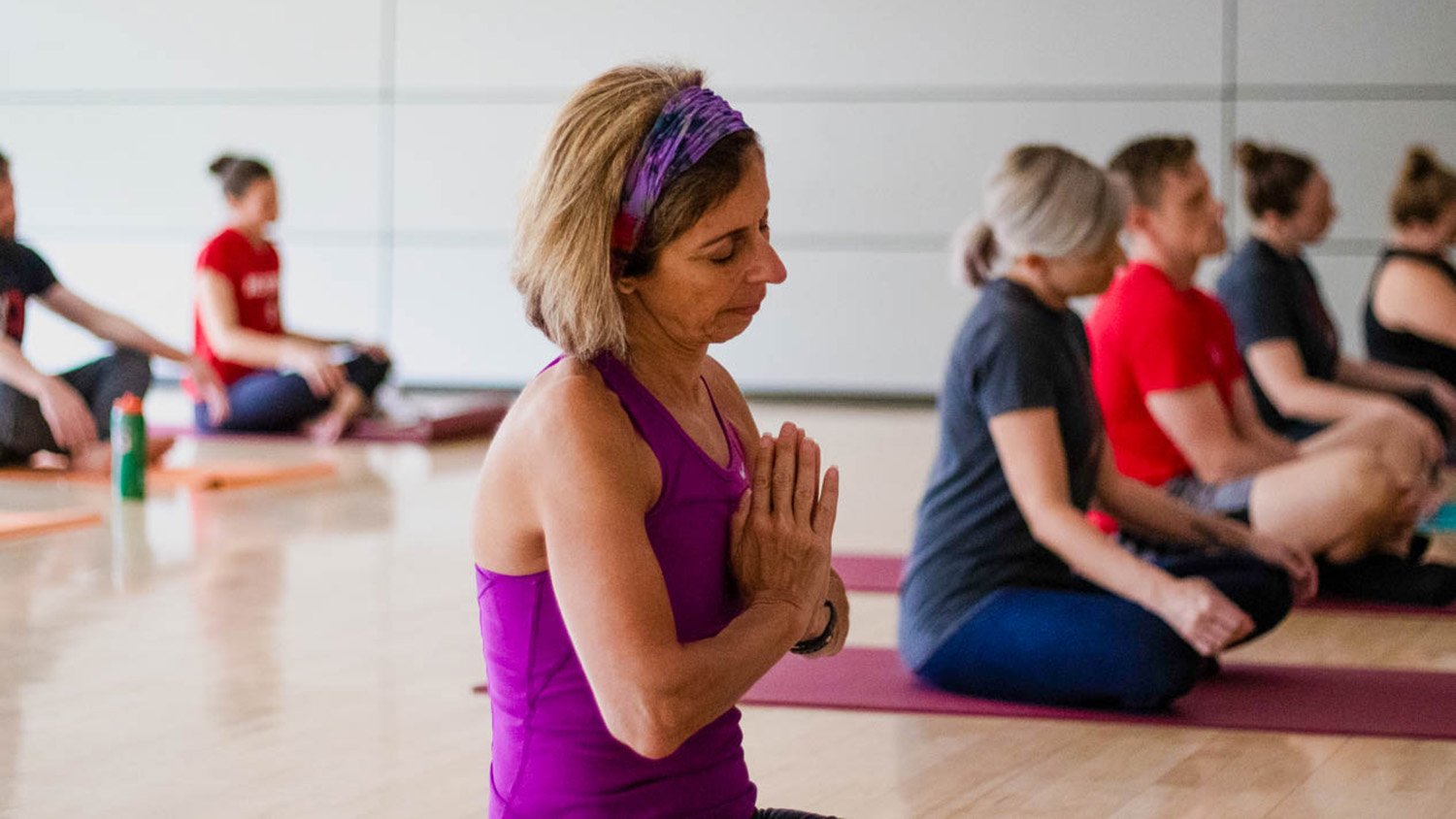 Staff members participate in a yoga class.