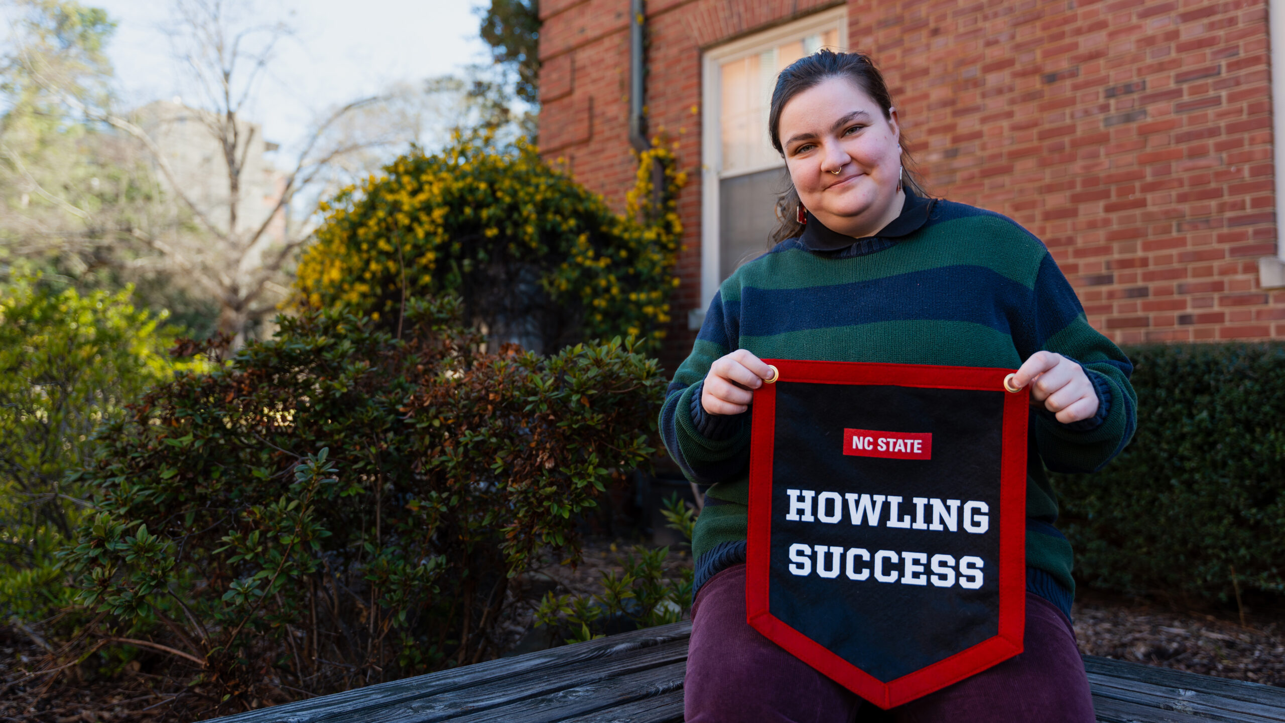 Bee Mangine proudly displays their Howling Success banner.