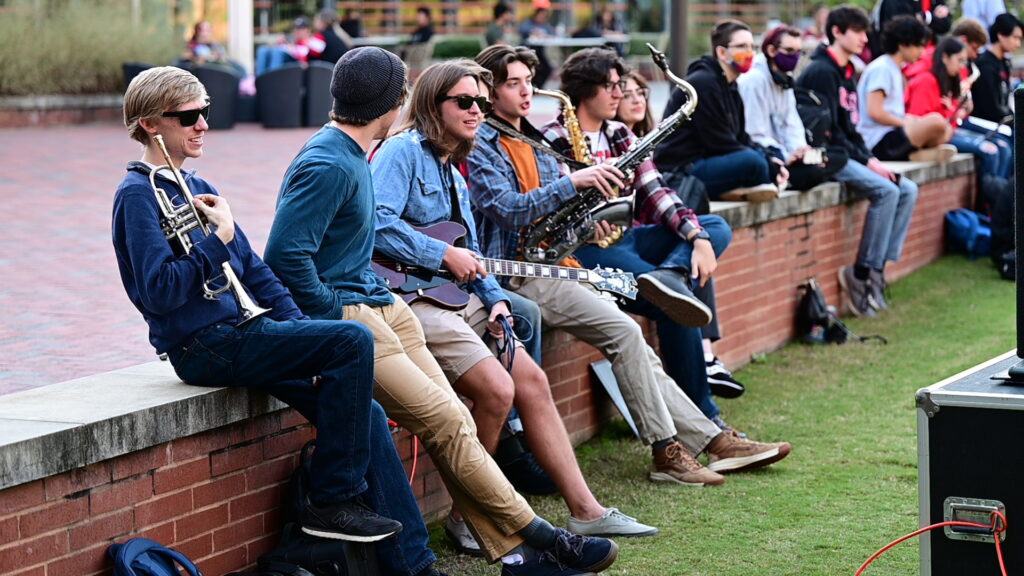 Members of the NC State jazz band relax on Stafford Commons.