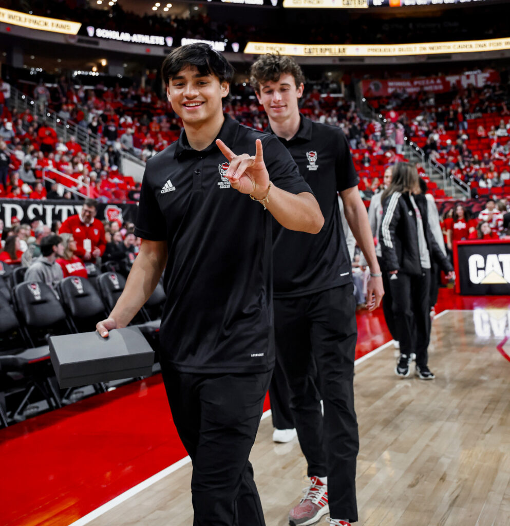 Caden Tolentino throws up his "Wolfie" at Lenovo Center. 