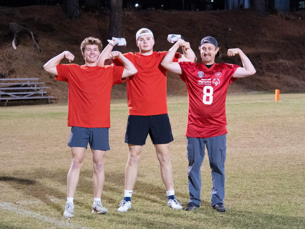 Three Unified Sports participants flex their biceps for a photo-op.