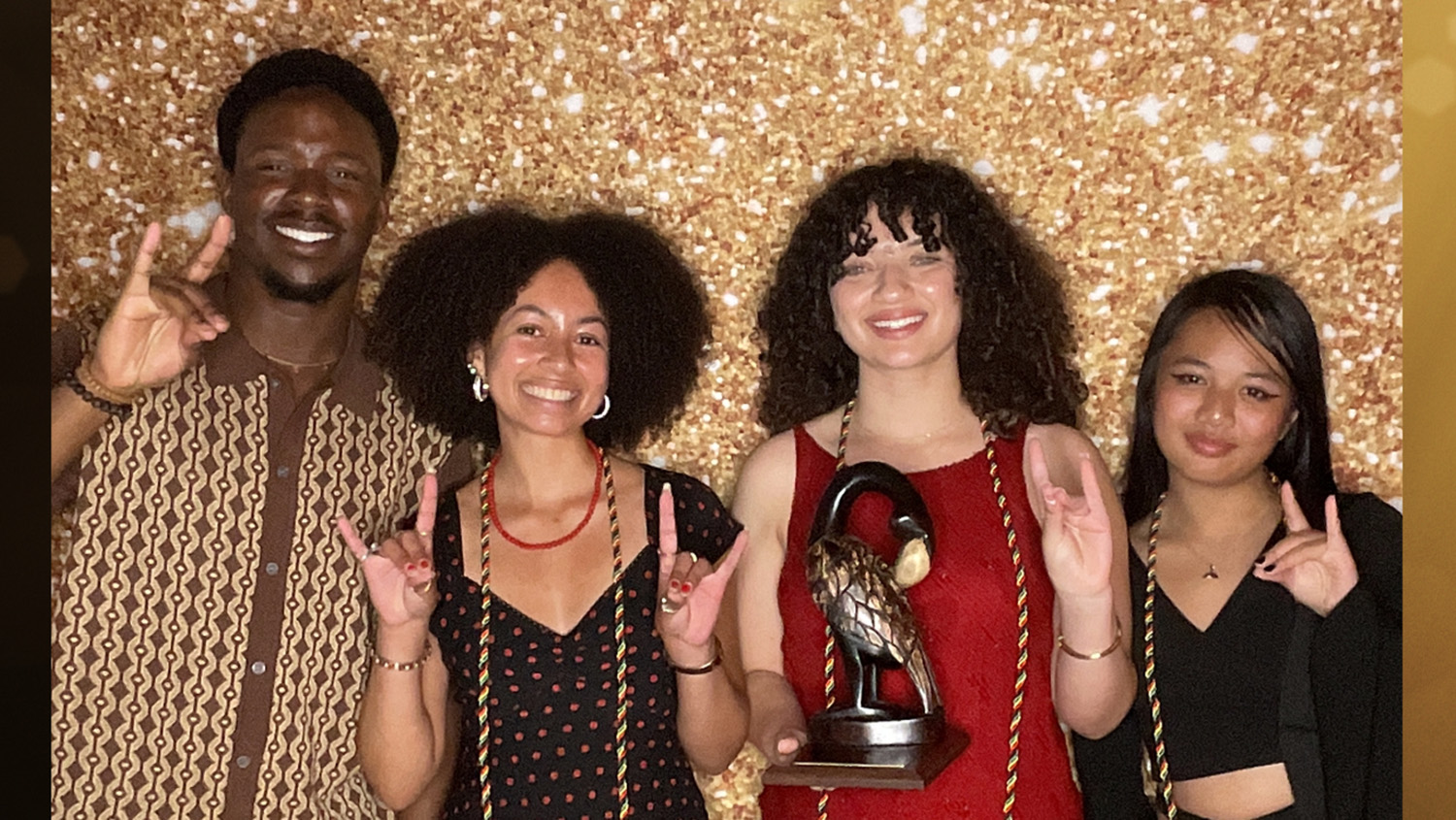 Members of The Nubian Message celebrate their Ebony Harlem organization award on April 13.