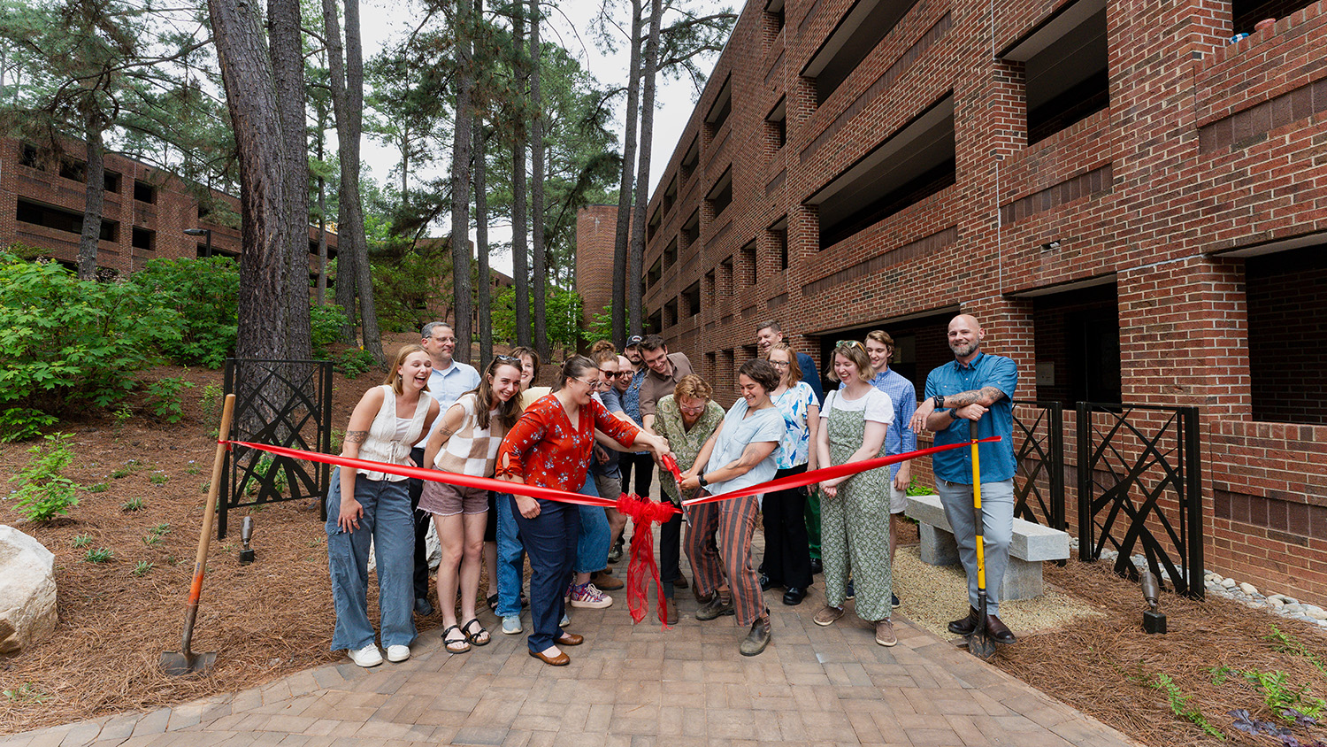 Students, professors and University Housing employees cut the ribbon on the new Wood Hall courtyard.
