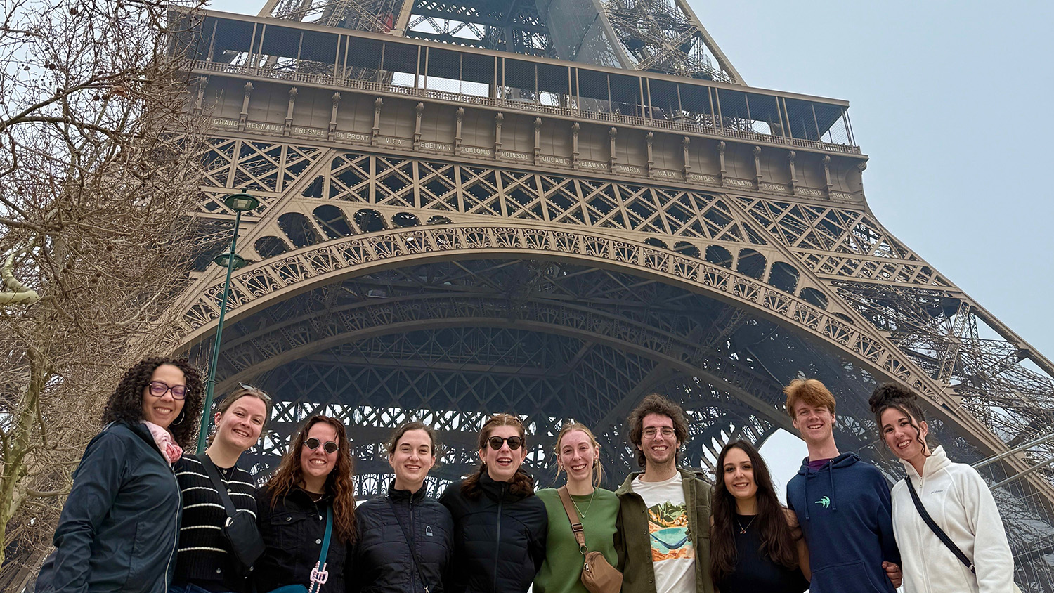 University Honors Program students standing in front of the Eiffel Tower in Paris, France.