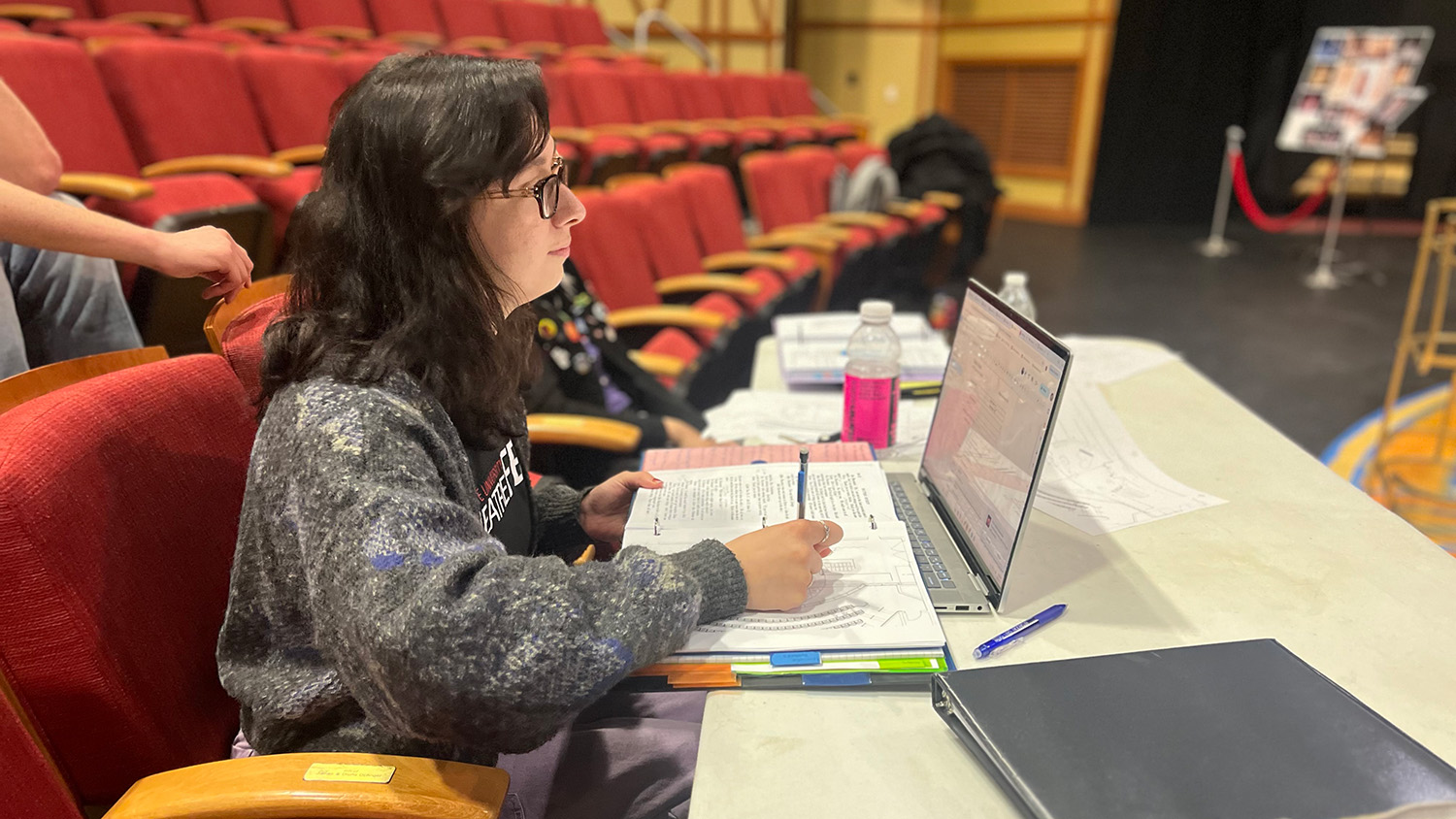 Rebecca Peace stage manages a production of Blithe Spirit.