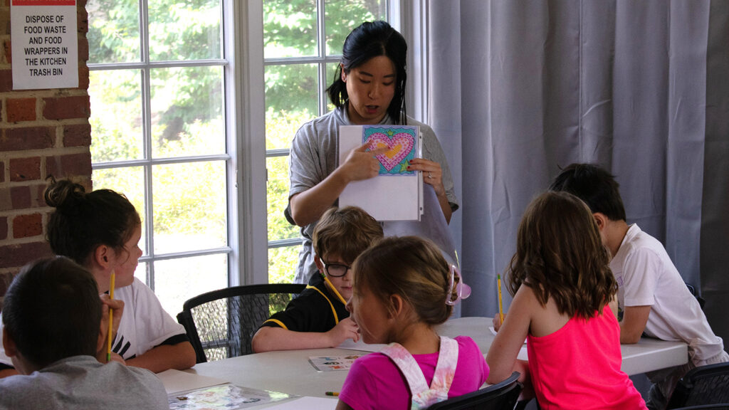 Gregg Museum Education Coordinator Tamara Velasco leads a group of children in an art activity.