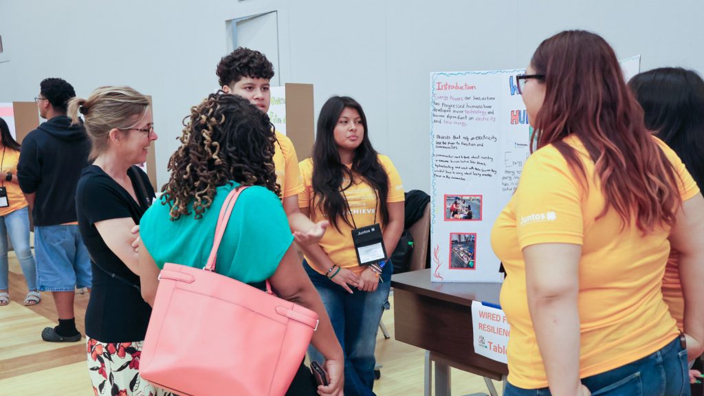 Juntos students present their group project.