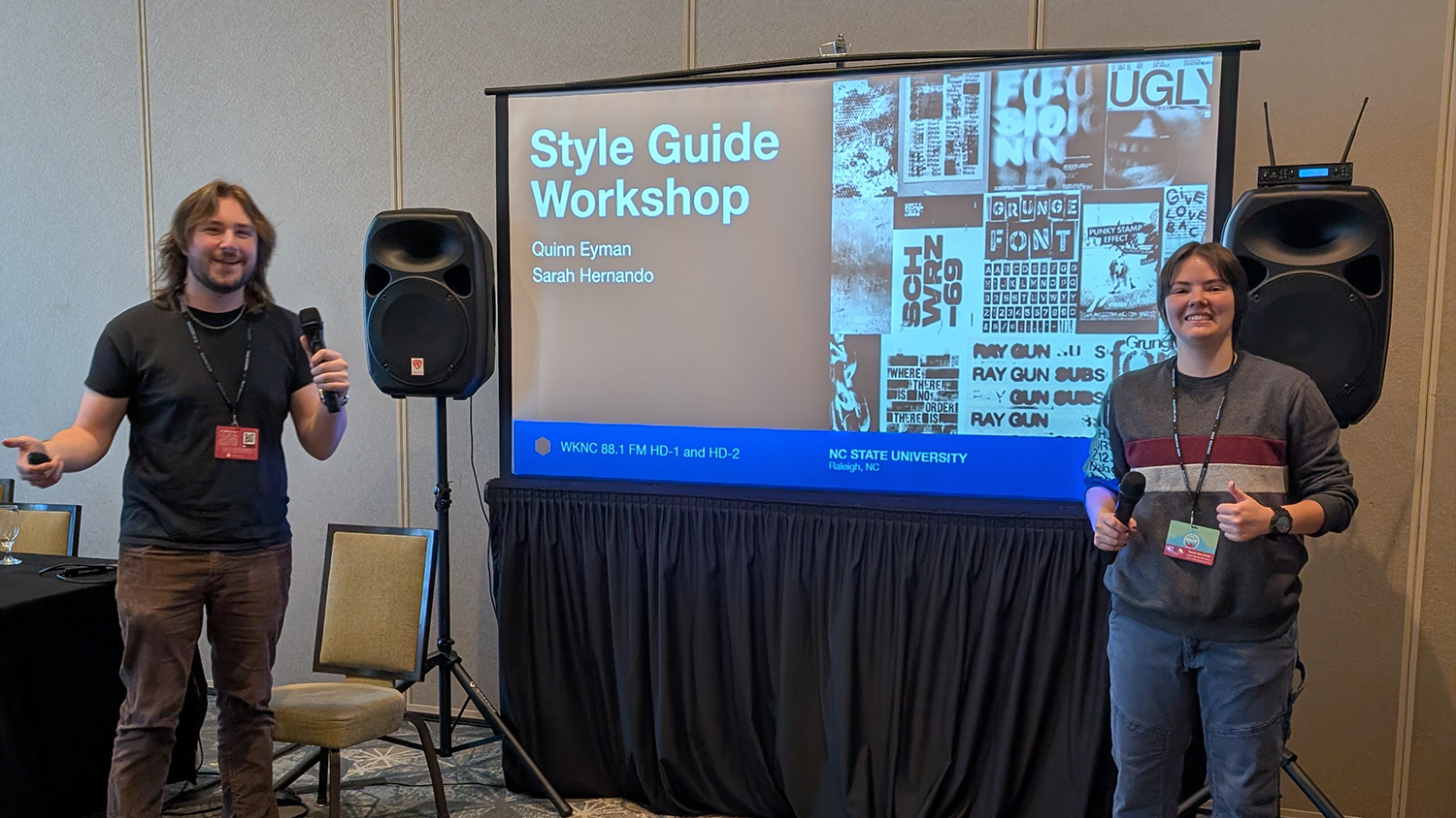 Two students stand in front of a screen that reads Style Guide Workshop.