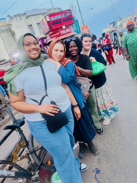 April Aguila and Jaida Ellis with Haddy Njie and other participants on the Gambia trip.